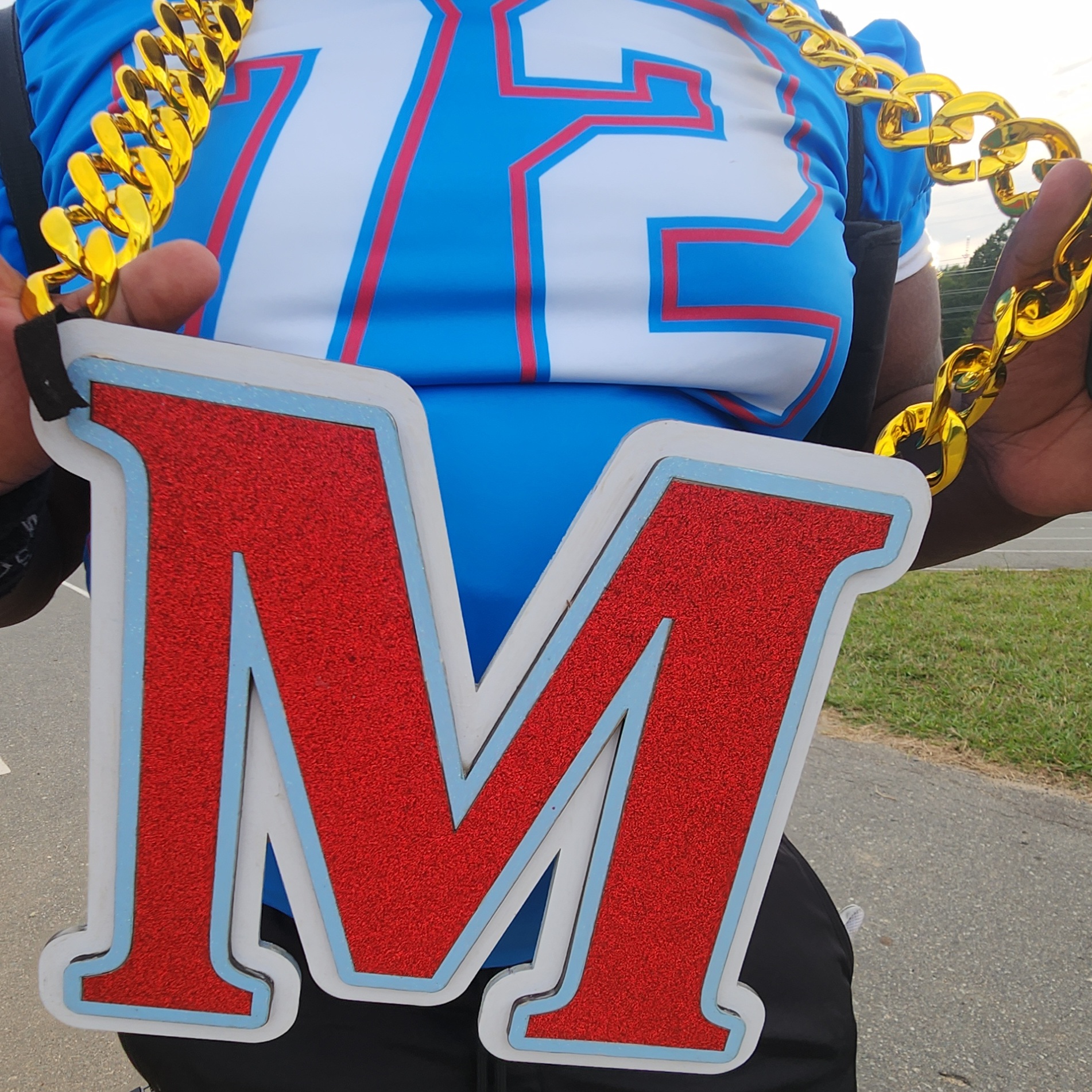 Custom sports chain worn on the sideline, red glitter letter